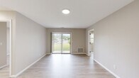 Located at 1503 Hillside Ave in Schenectady, NY, this single-floor, three-bedroom, two-bathroom home offers a clean, functional layout with a neutral, move-in-ready aesthetic throughout. Light wood-style flooring flows consistently across the living areas and bedrooms, creating a cohesive and bright atmosphere.

The living room is an open, well-lit space featuring a sliding glass door that fills the room with natural light and provides direct views of the surrounding greenery outdoors. The kitchen is equipped with warm oak cabinetry, light countertops, a double stainless steel sink, and white appliances including a dishwasher, electric range, and microwave — offering ample storage and functionality.

The primary bedroom is generously sized and includes a sliding door access point, providing additional natural light. The two additional bedrooms are well-proportioned with neutral walls and standard closets, making them versatile spaces. A dedicated walk-in style closet with wire shelving provides extra storage capacity.

Both bathrooms feature light beige tile flooring and crisp white finishes, including white vanity cabinetry. One bathroom includes a bathtub, while the other is configured as a half-style bath. A connecting hallway ties all rooms together in an efficient, easy-to-navigate floor plan ideal for everyday living.