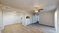 Located at 3602 Block Dr in Irving, TX, this single-story, 3-bedroom, 2-bathroom home offers a practical and well-organized layout. The combined living and dining area serves as the heart of the home, featuring wood-look flooring, a ceiling fan with light fixture, a textured ceiling, and built-in shelving that adds functional character. A pass-through window connects this space to the kitchen, enhancing the open feel between the two areas.

The galley-style kitchen is efficiently designed with white cabinetry, granite-look countertops, a stainless steel refrigerator, stainless steel range, and dishwasher. Wood-look flooring continues throughout, and a chandelier overhead adds a touch of warmth. A pantry provides additional storage.

The three bedrooms are finished with neutral tones and wood-look flooring, offering a clean and versatile canvas. The primary bedroom includes a walk-in closet with multi-level shelving for generous storage. The secondary bedrooms are well-proportioned, with one featuring a window that brings in natural light.

Both bathrooms are identically appointed with white tile tub-shower combinations, granite-look vanity countertops, white cabinetry, and wood-look flooring. A hallway connects the bedrooms and bathrooms, completing the home's straightforward and functional floor plan.