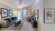 Located at 2951 Satellite Blvd in Duluth, Georgia, this single-floor residence offers a thoughtfully designed layout that balances comfort and functionality across a generous floor plan. The living room serves as the heart of the home, featuring crown molding, plush carpeting, a ceiling fan, and large windows dressed with decorative drapes that allow abundant natural light to flow in. A sliding glass door opens directly to a private balcony, extending the living space outdoors.

Adjacent to the living room, the dedicated dining area is highlighted by an elegant pendant light fixture and crown molding, creating a refined setting for gatherings. The kitchen is well-equipped with white cabinetry, dark granite-style countertops, stainless steel appliances, and ample storage including upper cabinets that extend to the ceiling.

The primary bedroom is generously sized with vaulted ceilings, a ceiling fan, walk-in closet, and a large window that invites natural light. Its en-suite bathroom features a wide vanity with dark countertops, white cabinetry, a large mirror, and a shower. A second bedroom offers similar comfort with its own ceiling fan, walk-in closet, and convenient access to a second full bathroom, which mirrors the finishes of the primary bath. Warm-toned carpet and wood-style flooring are used throughout to unify the space.