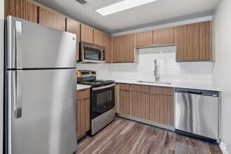 Renovated kitchen with stainless steel appliance package - Azul Apartment Homes