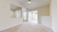 Located at 10015 Parthenon Court in Charlotte, NC, this 2-bedroom, 2-bathroom home offers a well-designed single-floor layout that maximizes functionality. The living area impresses with vaulted ceilings, a ceiling fan, and a pass-through window connecting to the kitchen, creating an open and airy atmosphere. Large multi-pane windows flood the space with natural light and provide views of the surrounding neighborhood. Soft, neutral-toned carpet covers the living and bedroom areas, complementing the warm wood-look vinyl flooring found throughout the kitchen and bathrooms. The kitchen is well-appointed with white shaker-style cabinetry, light quartz countertops, a subway tile backsplash, and a full suite of stainless steel appliances including a range, microwave, dishwasher, and refrigerator. The primary bedroom is generously sized, featuring a ceiling fan, a large window with outdoor views, and ample closet space. The second bedroom also offers good natural light and a double-door closet. Both bathrooms are clean and functional — one featuring a pedestal sink with an octagonal mirror, and the other with a soaking tub and a tall, narrow window for natural light. The hallway connects all rooms efficiently, completing this cohesive and comfortable home.