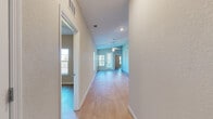 Located at 2796 Spring Orchard Ave in the charming city of Mt. Dora, Florida, this single-story home offers a well-designed, functional layout with consistent finishes throughout. Light wood-style flooring flows seamlessly across all living areas, complemented by neutral-toned walls and clean white trim and baseboards that create a bright, cohesive aesthetic.

The kitchen is well-appointed with rich warm-toned wood cabinetry extending to the ceiling for ample storage, granite countertops with subtle veining, a tile backsplash, and a full suite of stainless steel appliances including a range, microwave, and refrigerator. Double louvered doors provide access to a dedicated pantry or utility area. The kitchen opens toward the living area, which benefits from natural light through multiple windows and is equipped with a ceiling fan.

A wide hallway connects the living spaces to the bedrooms, each of which features light flooring, a ceiling fan, a window for natural light, and built-in closet storage — including a mirrored sliding-door closet in one bedroom. The bathrooms are finished with matching granite-topped vanities and warm wood cabinetry. One bathroom includes a tub-shower combination, while the primary bathroom features a walk-in shower and additional linen storage. French-style rear doors add a welcoming touch to the living area.