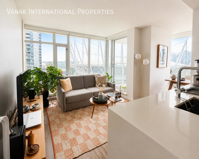 Photo du bâtiment - Bright 1 Bed + Den + Solarium | Pool, Gym & Rooftop Patio
