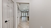 This 640-square-foot, one-bedroom, one-bathroom apartment at Haven 5207 in McKinney, TX is designed with modern finishes and a functional open-concept layout. The combined kitchen and living area serves as the heart of the home, featuring light wood-look vinyl flooring, crown molding, and a ceiling fan. The kitchen is well-appointed with white cabinetry, granite countertops, a curved peninsula with a built-in sink, a tile backsplash, and a full suite of stainless steel appliances including a refrigerator, electric range, built-in microwave, and dishwasher. Pendant lighting illuminates the peninsula, adding a stylish touch. The living area offers access to the outdoors through glass-paneled doors that allow ample natural light to fill the space. The 140-square-foot bedroom is carpeted and features crown molding, a ceiling fan, and a window with blinds for natural light and privacy. A closet with louvered doors provides dedicated storage. The bathroom includes a full tub-shower combination, wood-look vinyl flooring, and clean white finishes. Additional conveniences include a hallway, in-unit laundry, and a dedicated closet, making this apartment a complete and efficient living space.