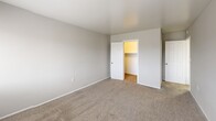 This 2-bedroom, 1-bathroom single-story home on Colgate Drive in Inkster, Michigan offers a practical and comfortable layout. The combined living and dining area is a welcoming open space featuring neutral-toned carpeting and a sliding glass door that fills the room with natural light and provides outdoor access. The kitchen is outfitted with white cabinetry, light countertops, and a gas range with overhead ventilation, complemented by a separate pantry for additional storage. The full bathroom features a tub/shower combo, a white vanity with storage, and wood-look flooring. Both bedrooms are carpeted and bathed in natural light from wide windows with outdoor views. The spacious primary bedroom includes a walk-in closet, while the second bedroom features a standard closet. Throughout the home, an abundance of five closets total ensures ample storage. A dedicated utility room adds further functionality. The home is finished with a consistent neutral color palette, white trim, and clean lines, creating a bright and tidy atmosphere throughout. A welcoming entrance completes this well-organized single-floor residence.