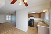 Located at 1645 Carol Sue Ave in Gretna, Louisiana, this single-floor, one-bedroom, one-bathroom unit offers a practical and comfortable layout. The living room is a bright, open space featuring plush carpeting and a ceiling fan with light fixture, creating a welcoming atmosphere. It flows naturally toward the combined dining and kitchen area, where wood-look flooring, warm wood cabinetry, a black range with overhead microwave, and a sink with countertop workspace make for a functional cooking environment. A dedicated pantry adds extra storage convenience just off the kitchen. The bedroom is a generously sized, carpeted retreat equipped with its own ceiling fan and a natural light source through a window with blinds. A walk-in closet is accessible directly from the bedroom, complemented by additional closet spaces throughout the unit — four in total — providing excellent storage capacity. The bathroom features wood-look flooring, a vanity with storage, and a full bathtub/shower combination. A hallway connects the main living areas to the private spaces, and a patio extends the living space outdoors. Ceiling fans are present in multiple rooms, enhancing comfort throughout the unit.