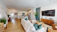 This two-story home on Barwell Dr in Charlotte, NC offers a well-designed layout across two floors. The main floor features an open-concept living, dining, and kitchen area unified by light hardwood flooring and recessed lighting throughout. The living room is bright and welcoming, with natural light flowing in from a front-facing entry and windows. A teal accent wall adds a bold architectural detail that visually connects the dining area and kitchen, while a modern chandelier anchors the dining space.

The kitchen is outfitted with white shaker cabinetry, granite countertops, a subway tile backsplash, stainless steel appliances, and a central island with bar seating — ideal for both cooking and casual dining.

Upstairs, the primary bedroom is generously proportioned, featuring a tray ceiling, large windows with outdoor views, and plush carpeting. The primary bathroom includes a dual-sink vanity with white cabinetry and direct access to a walk-in closet equipped with wire shelving. Two additional bedrooms provide flexible space for various needs. A dedicated laundry area with a full-size washer and dryer adds everyday convenience. The home presents a clean, modern aesthetic throughout.