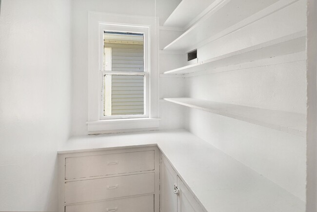 Spacious pantry with ample shelving for storage. - 1534 N Marshall St