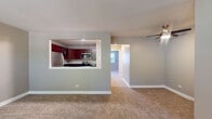 Located at 15 Briar St in Glen Ellyn, IL, this single-floor unit offers a well-organized layout designed for comfortable everyday living. The spacious living area is finished with neutral-toned carpet and painted walls, and features a ceiling fan overhead. A pass-through window connects the living space directly to the kitchen, creating an open, communicative flow between the two areas while maintaining distinct zones.

The kitchen is well-appointed with rich mahogany-toned cabinetry, dark granite countertops, and light hardwood-style flooring. Stainless steel appliances include a refrigerator, range, built-in microwave, and dishwasher, offering a modern and functional cooking environment.

The bedrooms are carpeted and feature neutral wall tones, with windows that allow natural light to filter in. One bedroom includes a closet and access to a bathroom, while another offers a walk-in closet area. Baseboard heating runs along the perimeter of several rooms, providing efficient climate control throughout.

The bathroom is cleanly finished with a dark wood vanity, white basin sink, framed mirror with lighted fixture, and a full tub-shower combination with white tile surround. The overall ambiance of the space is clean, neutral, and move-in ready.