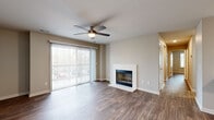 Located at 219 Arbor Lake Blvd in Nashville, TN, this well-appointed 2-bedroom, 2-bathroom residence offers a thoughtfully designed single-floor layout with a cohesive, modern aesthetic throughout. Rich wood-look flooring flows seamlessly across every room, complemented by neutral warm-gray walls and crisp white trim.

The combined kitchen and living area serves as the heart of the home. The living room features a classic fireplace with a clean white surround, a ceiling fan with light fixture, and a large sliding glass door that fills the space with natural light and opens to a private balcony. The galley-style kitchen is outfitted with white shaker cabinets, white countertops, subway tile backsplash, and a full suite of stainless steel appliances including a refrigerator, range, microwave, and dishwasher. A peninsula with an integrated sink and breakfast bar connects the kitchen to the living area.

The primary bedroom offers a generous footprint with a ceiling fan and a dedicated closet featuring built-in shelving. Both bathrooms maintain a clean, consistent design with white vanity cabinetry, white countertops, and wood-look flooring. One bathroom includes a full soaking tub with shower combination. A connecting hallway links all rooms efficiently, completing this functional and stylish Nashville residence.