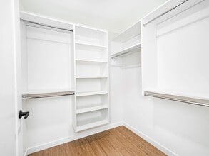 Spacious closet with built-in shelving and hanging space, offering a streamlined solution for organized storage and everyday ease. - Modera Bridle Trails
