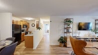 Located at 946 Sea Shell Ct in Rural Hall, NC, this single-floor, 2-bedroom, 2-bathroom home offers a thoughtfully designed layout that maximizes every inch of its footprint. Light-toned luxury vinyl plank flooring runs throughout the main living areas, creating a cohesive and easy-to-maintain foundation across the space.

The living room serves as the heart of the home, featuring a ceiling fan, natural light from windows, and a distinctive sage green accent wall that adds a warm, modern character. It flows naturally into the combined dining and kitchen area, where a peninsula with a light countertop separates the spaces. The galley-style kitchen is outfitted with warm honey-toned wood cabinetry, a white tile backsplash, black appliances, and generous counter space on both sides. The dining area includes a convenient closet housing a full-size washer and dryer.

Both bedrooms are carpeted and offer closet storage, with the primary bedroom featuring a double-door closet and direct access to a full bathroom. The bathrooms are finished with wood-toned vanities and tub-shower combinations with hardwood-style flooring, maintaining a consistent, clean aesthetic throughout the home.