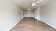 Located at 2816 Eden St in Pascagoula, Mississippi, this single-floor, 2-bedroom, 2-bathroom home offers a practical and comfortable layout with consistent, modern finishes throughout. The living room makes a welcoming impression with warm wood-look laminate flooring, soft gray walls, a ceiling fan with integrated lighting, and elegant French doors that flood the space with natural light and provide access to the outdoors. The layout flows seamlessly into the kitchen, which features rich dark wood cabinetry, granite-look countertops, tile flooring, and a full suite of appliances including an electric range, built-in microwave, dishwasher, and refrigerator. Both bedrooms are carpeted for comfort and each includes a ceiling fan and natural light from well-positioned windows. The primary bedroom offers a generous footprint with a double-door closet for ample storage. The two bathrooms are finished with warm earth-toned tile flooring and walls. One includes a full tub-shower combination with stylish tile surround, while the other features a rich wood vanity with granite-look countertop and a large mirror. A hallway and closet round out the well-organized floor plan, making this home efficient and easy to navigate.