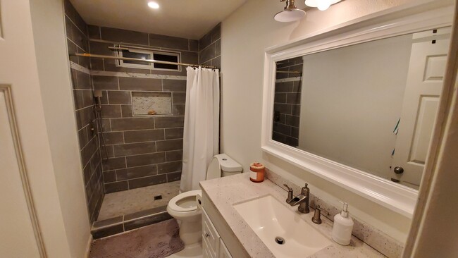 New Bathroom, stone pebble shower floor - 2240 Raymond Ln