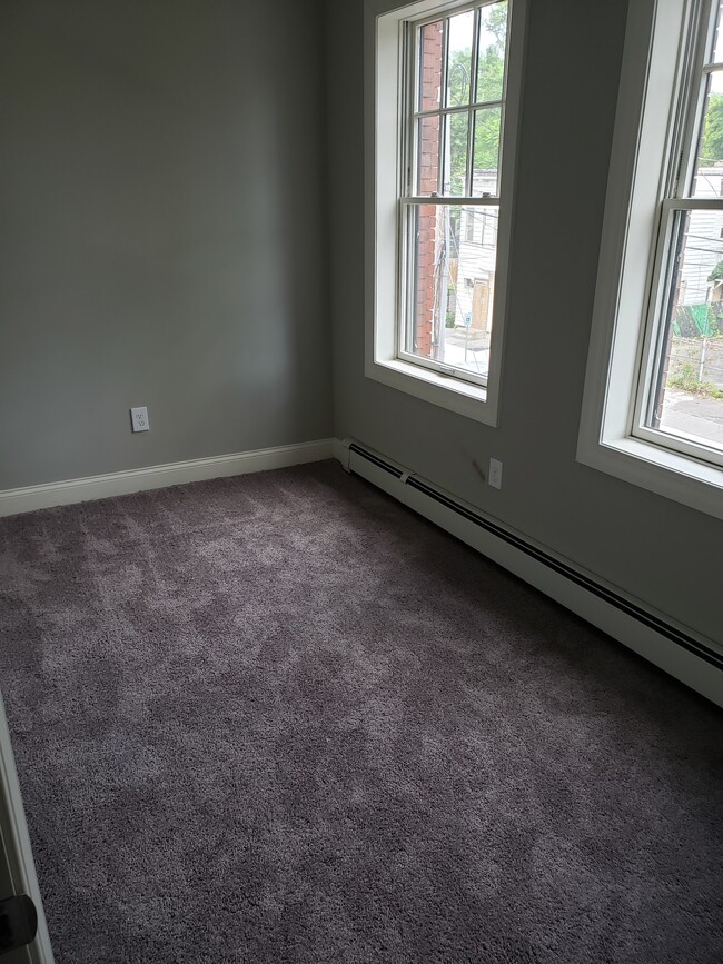 Bedroom #3, measures approx. 10 ft by 7 ft. Bedroom has two windows. Contains a closet. - 2 Judson St