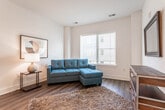 Located at 41 Berry St in Somerset, NJ, this single-floor residence offers a thoughtfully designed open-concept layout with a clean, contemporary aesthetic throughout. Rich hardwood flooring extends across the main living areas, anchoring the space with warmth and continuity.

The living area is bright and welcoming, benefiting from a large window that invites natural light and provides views of the surrounding neighborhood. The kitchen is a functional centerpiece of the unit, featuring stainless steel appliances including a gas range, microwave, and refrigerator, complemented by granite countertops, a gray tile backsplash, white upper cabinetry, and wood-toned lower cabinetry. A peninsula with seating for two adds casual dining convenience, while pendant lighting overhead enhances the modern feel.

The unit includes two bedrooms, each carpeted for comfort and equipped with windows that allow natural light. One bedroom features a walk-in closet with wire shelving for organized storage. The full bathroom is finished with large-format floor tiles, a tub-shower combination with mosaic tile accents, and a white vanity. An in-unit washer and dryer adds everyday convenience to this well-appointed Somerset residence.