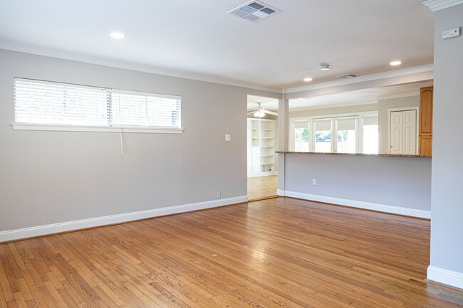 Living room opens into kitchen and sunroom/den. - 3618 Broadmead Dr