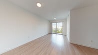 Located at 13081 SW 242nd St in Homestead, Florida, this single-floor unit offers a clean, modern aesthetic throughout. Light wood-style flooring flows seamlessly across all living areas, creating a bright and cohesive interior. The open-concept living area is bathed in natural light, courtesy of a large sliding glass door that opens to an outdoor view and allows sunlight to fill the space. Recessed and flush-mount ceiling fixtures provide additional illumination throughout.

The kitchen is well-appointed with rich, dark espresso cabinetry, granite countertops, and a full suite of stainless steel appliances, including a refrigerator, electric range, built-in microwave, and dishwasher. Track lighting above the kitchen adds both function and style.

The bedroom features light wood flooring, a generous closet with built-in shelving, and a window that invites natural light. The bathroom is finished with tile flooring, large-format tile surrounding the bathtub and shower, a granite-topped vanity with dark wood cabinetry, and a full-width mirror. The overall design emphasizes clean lines, neutral tones, and functional layouts, making this a well-structured and move-in ready space.