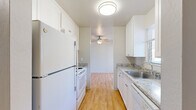 Located at 1450 Creekside Dr in Walnut Creek, CA, this one-bedroom, one-bathroom residence offers a practical and well-appointed single-floor layout. The galley-style kitchen is outfitted with white cabinetry, granite-style countertops, a stainless steel sink, and white appliances including a refrigerator, oven/range, and dishwasher. Light wood flooring runs throughout the kitchen, which opens toward the dining area, where a ceiling fan adds comfort and airflow. The dining room connects smoothly to the main living areas, creating an efficient flow throughout the home. The bedroom is generously sized, featuring plush wall-to-wall carpeting, a sliding door closet, and direct access to a private balcony that brings in natural light and outdoor views. The full bathroom is finished with matching granite-style countertops, white cabinetry, a combined shower/tub, and warm wood-tone flooring. A hallway connects the key spaces of the home, enhancing privacy between the living and sleeping areas. A separate entry area with a sliding glass door and vertical blinds provides additional balcony access and natural light. The overall design is clean, bright, and functional, making efficient use of the available space.