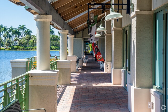 Boardwalk near pond with retail and restaurants in Park of Commerce.