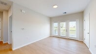 Located at 340 Frontier Way in Sunbury, Ohio, this well-appointed one-bedroom, one-bathroom unit offers a thoughtfully designed layout across a single floor. The open-concept kitchen and living area serves as the heart of the home, featuring light hardwood-style flooring, white shaker cabinetry, a quartz waterfall-edge island with an undermount sink, stainless steel appliances, and stylish pendant lighting. The living area is bright and airy, with neutral walls and French doors that lead to a private balcony offering outdoor views of the surrounding greenery. The bedroom is carpeted for comfort, equipped with a ceiling fan, and includes a window with scenic outdoor views, along with a closet for storage. The bathroom is clean and modern, showcasing tile-surround tub and shower combination with light wood-tone flooring. A dedicated laundry area houses a stacked washer and dryer unit, adding everyday convenience. A utility room and hallway complete the functional floor plan. The consistent use of neutral tones, natural light, and contemporary finishes gives the entire space a cohesive, move-in-ready feel.