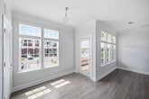 This 760-square-foot, single-floor apartment features 2 bedrooms and 1 bathroom across a well-organized layout. The open-concept kitchen and living area serves as the heart of the home, showcasing rich dark-cabinetry, granite countertops, stainless steel appliances, a peninsula with pendant lighting, and crown molding throughout. Light wood-look flooring flows seamlessly across all rooms, complementing the neutral color palette. The living area is bright and airy, benefiting from large windows with blinds that invite abundant natural light. The primary bedroom measures 180 square feet and features a ceiling fan, natural light from multiple windows, and access to a dedicated walk-in closet outfitted with wire shelving systems. The second bedroom also includes a ceiling fan and windows. The full bathroom offers a dark-wood vanity with granite countertop, a full tub-shower combo, and matching wood-look flooring. A dedicated laundry room houses a full-size side-by-side washer and dryer. A hallway connects the living areas to the private bedrooms, completing this efficient and modern floor plan located in Brentwood, Wake County, NC.