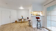 This 500 square foot apartment in Austin, TX offers a thoughtful layout maximizing space efficiency. The open-concept design combines the kitchen and living room, creating a sense of spaciousness. The kitchen features white appliances and two-toned cabinetry, complemented by light wood-look flooring throughout.

The primary bedroom, measuring 110 square feet, includes a ceiling fan and large windows for natural light. Both bedrooms boast ample closet space. The bathroom is well-appointed with a single vanity and a shower/tub combination.

The apartment includes an in-unit laundry area, adding convenience to daily life. Ceiling fans in main living areas help maintain comfort and airflow. The property exterior features white siding and balconies, set amidst landscaped grounds with grassy areas.

Located in a multi-building complex, residents can enjoy community amenities and a suburban feel within the city. The efficient use of space and modern updates make this apartment an attractive option for those seeking a cozy yet functional living environment in Austin.