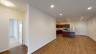 Located at 6343 Logans Ln in Lynchburg, Virginia, this single-floor residence offers a thoughtfully designed layout with consistent finishes throughout. The open-concept living and dining area is finished with durable wood-style flooring and recessed lighting, creating a bright and welcoming atmosphere. Large, neutral-toned walls provide a versatile backdrop, and natural light filters in through well-placed windows.

The kitchen is a standout feature, showcasing rich dark cabinetry, speckled granite countertops, and a full suite of stainless steel appliances including a refrigerator, electric range, microwave, and dishwasher. A central island provides additional prep and counter space, making the kitchen both functional and visually appealing.

The bedrooms are carpeted for comfort and include natural light from windows. A spacious walk-in closet with wire shelving offers generous storage. The bathrooms are finished with granite-topped vanities, rich cabinetry matching the kitchen, and wood-style flooring. One bathroom includes a full soaking tub and shower combination, while another features a walk-in shower and a window for natural light. Recessed lighting and clean white walls give the entire home a modern, move-in-ready feel.