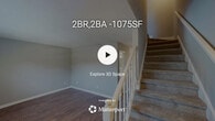 Located at 2920 Chapel Hill Rd in Durham, NC, this two-story, 2-bedroom, 2-bathroom home offers a practical and comfortable layout spread across two floors. The main level features a combined kitchen and living room area alongside a utility room. The kitchen is well-appointed with white cabinetry, dark countertops, and a full suite of stainless steel appliances, including a refrigerator, electric range with microwave, and dishwasher, all complemented by warm hardwood-style flooring. The living room is open and bright, with natural light streaming through windows and the same wood-style flooring continuing throughout. A second room on the main floor, also with hardwood-style floors, offers flexible use as a dining area or additional living space. Upstairs, two carpeted bedrooms each feature ceiling fans with light fixtures and windows that bring in natural light. The spacious primary bedroom includes two closets, providing ample storage. Both bathrooms are finished in neutral tones, with one featuring a tub/shower combination, wood-style floors, and a vanity with white countertops. Textured ceilings and neutral gray walls are consistent throughout, giving the home a clean, cohesive aesthetic.