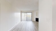 Located at 825 S Hobart Blvd in Los Angeles, CA, this 2-bedroom, 2-bathroom unit offers a thoughtfully designed single-floor layout. The living room is a bright, open space anchored by a fireplace and a floor-to-ceiling sliding glass door that fills the room with natural light and provides access to outdoor views. Built-in wall shelving adds a functional architectural detail to the living area. Light wood-style flooring and a textured ceiling run consistently throughout, creating a cohesive and clean aesthetic.

The kitchen features white cabinetry, granite-style countertops, and a stainless steel range, offering ample storage and counter space. Both bedrooms are generously proportioned, with the primary bedroom offering built-in sliding-door closets and multiple windows dressed with vertical blinds. The second bedroom also benefits from natural light through its windows.

Each of the two bathrooms is finished with matching granite-style vanity countertops, white cabinetry, and a tub-shower combination with sliding glass doors. Two hallways connect the rooms efficiently throughout the layout. The unit's neutral color palette, consistent flooring, and practical finishes create a clean, move-in ready environment well-suited for comfortable urban living in the heart of Los Angeles.