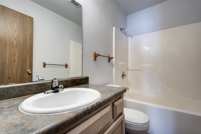 One bedroom bathroom - Sunset Woodland Apartments