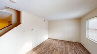 Located at 645 Winnie Street in Lexington, Kentucky, this two-story home offers 3 bedrooms, 2 bathrooms, and a practical, well-organized layout spread across two floors of nearly equal size. The main floor features a bright living room with wood-look flooring, neutral cream-toned walls, and a textured ceiling, allowing natural light to flow freely throughout. A staircase connects both levels, complementing the home's functional flow. The combined dining and kitchen area is a standout on the main floor, equipped with warm cherry-toned cabinetry, granite-look countertops, a double-basin sink, and white appliances including a range and refrigerator. Hardwood-style flooring continues throughout, adding visual continuity. Upstairs, three bedrooms provide comfortable accommodations, including a generously sized primary bedroom. Each bedroom features wood-look flooring, neutral walls, and windows that bring in natural light. Several bedrooms include built-in closets with sliding or paneled doors. The home also boasts an impressive seven closets total, offering exceptional storage. The two bathrooms include one with a full tub/shower combination with chrome fixtures, and another with a vanity, mirror, and tile flooring. This home delivers a clean, functional living environment in a convenient Lexington location.