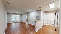 Located at 4013 Wilshire Blvd in Wilmington, NC, this single-story residence offers three bedrooms, three bathrooms, and a thoughtfully designed floor plan that balances comfort and functionality. Warm hardwood flooring flows consistently throughout the living areas and bedrooms, lending the space a cohesive and inviting character.

The kitchen is a standout feature, outfitted with white shaker cabinetry, granite countertops, stainless steel appliances including a range, microwave, refrigerator, and dishwasher, and a peninsula with bar seating that opens to the living area. This open-concept layout enhances the sense of space and facilitates easy movement between rooms.

The living room is bright and airy, with natural light entering through French doors that provide outdoor views and contribute to the open, relaxed ambiance. The bedrooms are generously sized, with the primary bedroom offering ample space and a dedicated closet. The additional bedrooms also feature closets and windows that allow natural light to filter in.

Each of the three bathrooms is finished with tile flooring, white cabinetry with granite countertops, and tub-shower combinations. A dedicated laundry room with full-size washer and dryer and wire shelving adds practical convenience. Three closets throughout the home provide plentiful storage.