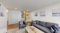 Located at 2223 Vermont View Dr in Watervliet, NY, this single-floor, one-bedroom, one-bathroom unit offers a well-organized layout that makes efficient use of its compact footprint. The living room serves as the central gathering space, featuring warm hardwood flooring, recessed lighting, and a large window fitted with layered roller shades that diffuse natural light throughout the room. A wall-mounted HVAC unit provides climate control, while neutral white walls create a bright, open feel.

The kitchen is thoughtfully appointed with shaker-style cabinetry in a soft grey-white finish, granite countertops, a white subway tile backsplash, and a full suite of stainless steel appliances including a range, refrigerator, and range hood. Light-toned tile flooring completes the clean, contemporary aesthetic. A small dining area sits adjacent to the kitchen, offering a natural transition between cooking and living spaces.

The bedroom is a calm, minimalist retreat with hardwood floors, white walls, and a wide window that allows ample natural light. The bathroom features a full bathtub and shower combination with floor-to-ceiling marble-look tile surround and chrome fixtures, conveying a polished, updated finish throughout.