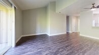 Located at 6000 Sunhill Cir in El Sobrante, CA, this well-appointed 2-bedroom, 2-bathroom single-floor residence offers a thoughtfully designed layout with a clean, contemporary aesthetic. The open living room impresses with vaulted ceilings and wide-plank wood-style flooring, creating a bright and airy atmosphere. Large sliding doors allow natural light to fill the space. The kitchen is well-equipped with crisp white shaker cabinetry, gray quartz-style countertops, a classic subway tile backsplash, and a full suite of stainless steel appliances including a refrigerator, range, and over-the-range microwave. Wood-style flooring continues throughout the kitchen, adding warmth and cohesion. Both bedrooms are carpeted and receive abundant natural light through generously sized windows with exterior views. The primary bedroom features mirrored sliding closet doors, enhancing the sense of space. The two bathrooms are finished with gray countertop vanities and wood-style flooring; one includes a full tub-shower combination. Additional highlights include three closets, two utility rooms, and a hallway connecting the layout efficiently. The overall palette of soft greens, whites, and grays lends the home a calm, modern character throughout.