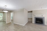 Located at 1901 Briarcliff Rd NE in Atlanta, GA, this single-floor, two-bedroom, two-bathroom residence offers a well-designed layout across a generous footprint. Wood-style flooring flows consistently throughout the home, complementing the neutral, warm-toned walls found in every room.

The living room serves as the centerpiece of the home, featuring a tile-surround fireplace with a white mantel and flanking built-in shelving units — ideal for display or storage. Natural light fills the space through large windows with blinds, and a sliding glass door opens to a private balcony overlooking lush, green tree canopy.

The kitchen is outfitted with white shaker-style cabinetry, granite countertops, a classic subway tile backsplash, a stainless steel sink, and a dishwasher, offering both style and functionality. An adjacent dining area provides comfortable space for everyday meals.

The primary bedroom is generously sized, accompanied by a well-appointed en-suite bathroom featuring a granite vanity, white cabinetry, and a full tub-shower combination. A spacious walk-in closet with wire shelving and hanging rods adds substantial storage. The second bedroom is equally comfortable, served by a second full bathroom with matching granite finishes. A connecting hallway ties the layout together cohesively.