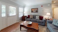 Located at 8650 Barbara Ann Way in Delmar, Maryland, this single-floor residence offers a thoughtfully designed layout with a warm coastal aesthetic throughout. The living room serves as a welcoming centerpiece, featuring a fireplace, crown molding, and soft neutral tones accented by light blue walls. Natural light filters through windows dressed with blinds, and hardwood flooring anchors the space with a classic feel.

The kitchen is well-equipped with warm maple cabinetry extending to the ceiling, granite-style countertops, and a full suite of appliances including a stainless steel dishwasher and microwave. A central island provides additional prep space and casual seating, making it functional for both cooking and entertaining.

The bedrooms carry a serene, coastal-inspired character. The primary bedroom is generously sized with multiple windows that flood the room with natural light, plush carpeting, and ample space for a seating area. Additional bedrooms continue the nautical theme, with one featuring a charming dresser with mirror and coastal artwork.

The bathrooms include a full bath with hardwood-style flooring and a whimsical sea-themed shower curtain, as well as a clean, minimalist full bath with wall-mounted sink and natural light. The overall ambiance of this residence is relaxed, cohesive, and beach-cottage inspired.
