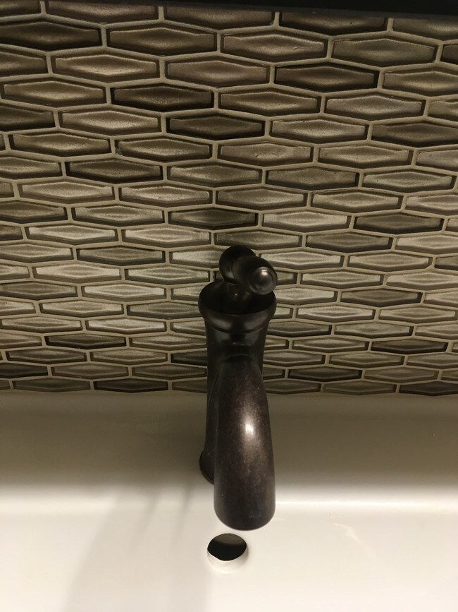 Faucet & back splash behind double sinks - 1851 Broadway St