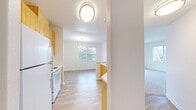 This 870 square foot home in San Ramon, California offers a well-designed living space on a single floor. The property features two bedrooms, including a primary bedroom of 190 square feet, and one bathroom. The layout is optimized for efficiency, with an open-concept design that combines the living room, dining area, and kitchen into one cohesive space.

The kitchen is equipped with wooden cabinetry, white appliances, and a practical breakfast bar, creating a functional cooking and casual dining area. The living and dining areas boast light-colored laminate flooring, enhancing the sense of space and brightness. Large windows in these areas provide natural light and views of the surrounding neighborhood.

Both bedrooms are carpeted for comfort and feature ample closet space. The bathroom is well-appointed with a combination tub and shower, a single vanity with storage, and vinyl flooring that complements the overall design.

Throughout the home, neutral-toned walls and ceilings create a blank canvas for personalization. The property also includes additional storage solutions, such as a separate closet area. Despite its compact size, this home efficiently utilizes every square foot to provide a comfortable living environment in a desirable San Ramon location.
