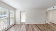 Located at 1600 Nesbitt Lane in Madison, TN, this 890-square-foot apartment at Breckenridge features 2 bedrooms, 2 bathrooms, and a thoughtfully designed single-floor layout. Consistent wood-look luxury vinyl flooring flows throughout the entire unit, complementing the clean white walls and crisp trim for a bright, cohesive aesthetic. The combined kitchen and living room area forms the heart of the home. The galley-style kitchen is equipped with gray shaker-style cabinetry, marble-look countertops, black stainless appliances including a refrigerator, range, and over-the-range microwave, and a skylight that fills the space with natural light. The spacious living area features large windows with blinds and a private exterior door. Both bedrooms include ceiling fans with light fixtures, wood-look flooring, and closets. The primary bedroom measures 180 square feet, offering ample space for furnishings. Each of the two full bathrooms features a tub-shower combo with a curved curtain rod, a vanity with marble-look countertops, gray cabinetry, and wood-look flooring. Two closets provide additional storage throughout the unit, completing this well-appointed apartment home.