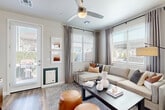 Located at 5801 S 51st Ave in Phoenix, AZ, this single-story, one-bedroom, one-bathroom residence offers a thoughtfully designed open-concept layout with modern finishes throughout. Light-toned walls, wood-style flooring, and large windows with slatted blinds create a bright and airy atmosphere across the entire living space.

The living room serves as a welcoming focal point, featuring dual corner windows that flood the room with natural light, a ceiling fan, and direct access to an outdoor area via a side door. The kitchen is well-equipped with stainless steel appliances, crisp white cabinetry extending to the ceiling, a light quartz-topped island with seating, and ample counter and storage space. Open shelving adds both functionality and visual interest where the kitchen meets the living area.

The bedroom is a comfortable retreat with a ceiling fan, a large window dressed in sheer curtains, a softly colored accent wall, and generous floor space. A dedicated closet and hallway provide additional storage and seamless flow to the full bathroom, which features a white vanity with modern hardware, a tub-shower combo with sliding glass doors, and wood-style flooring that ties the space together cohesively.