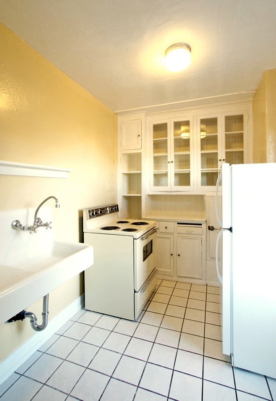 Charming retro kitchen with original porcelain farm style sink and glass front cabinets - 1621 17th Ave