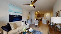 Located at 3200 W Colfax Ave in Denver, Colorado, this single-floor residence offers a thoughtfully designed open-concept layout that seamlessly connects the living, dining, and kitchen areas. Light wood-tone flooring runs throughout, creating a warm and cohesive aesthetic.

The kitchen is a standout feature, outfitted with rich wood-grain cabinetry, stainless steel appliances, white quartz countertops, a textured tile backsplash, and a peninsula island with pendant lighting — ideal for both everyday cooking and entertaining. Recessed lighting adds a bright, modern touch.

The living area is generously proportioned, featuring a ceiling fan and large windows that allow ample natural light to fill the space while offering views of the surrounding neighborhood. The open dining nook flows naturally from both the kitchen and living room, enhancing the sense of connectivity throughout the unit.

The bedroom is a comfortable retreat, complete with a closet, light-filled windows, and warm neutral tones. The bathroom features wood-grain cabinetry, a white vanity countertop, a glass-enclosed shower, and light wood flooring, delivering a clean, contemporary feel. Overall, the space strikes a balance between modern design and functional, everyday livability.