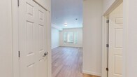 Located at 22455 NE Halsey St in Fairview, Oregon, this well-designed one-bedroom, one-bathroom residence offers a clean, modern aesthetic throughout its single-floor layout. Light wood-style flooring runs continuously across the space, lending warmth and visual cohesion to every room.

The open-concept kitchen and living area serves as the heart of the unit. The kitchen is equipped with stainless steel appliances — including a refrigerator, range, microwave, and dishwasher — paired with crisp white shaker-style cabinetry, gray countertops, and a undermount sink. Recessed lighting illuminates the space efficiently, while a structural column adds architectural definition between the kitchen and the living area.

The bedroom is a comfortable, well-proportioned room bathed in natural light from a set of windows fitted with horizontal blinds. A sliding-door closet provides practical built-in storage. Neutral white walls throughout create a clean, versatile backdrop.

The bathroom features a white vanity with gray countertop, an undermount sink with brushed nickel fixtures, a large mirror with overhead lighting, and a shower/tub combination. Light wood-style flooring continues here, maintaining design consistency. The overall ambiance of this residence is bright, modern, and move-in ready.