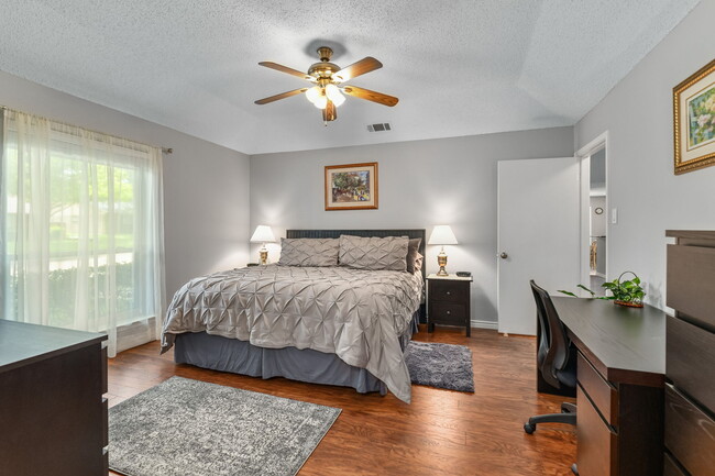 Master bedroom with King bed, walk-in closet, ensuite walk-in shower. Work desk - 7312 Augusta Cir