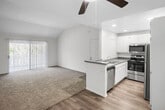 Located at 655 Baker St in Costa Mesa, California, this single-story home offers five bedrooms and two full bathrooms within a well-organized, efficient layout. The open-concept kitchen and living area form the heart of the home, featuring light wood-style flooring, white cabinetry, granite-style countertops, and a full suite of stainless steel appliances including a refrigerator, range, microwave, and dishwasher. A ceiling fan and recessed lighting add to the functionality of the living space. The five bedrooms are finished with wall-to-wall carpet and bright white walls, creating a clean and versatile environment. Several bedrooms feature windows with exterior views, allowing natural light to fill the rooms. One bedroom features a vaulted ceiling that adds a sense of openness. The two full bathrooms are finished with granite-style countertops, white cabinetry, and tub-shower combinations, complemented by large wall mirrors. A connecting hallway links the bedrooms and bathrooms, providing a logical and convenient flow throughout the home. The neutral color palette and clean finishes throughout make this Costa Mesa residence a practical and move-in ready option.