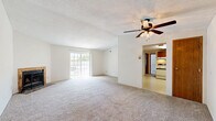 Located at 5334 Lees Crossing Dr in Cincinnati, Ohio, this single-floor, 2-bedroom, 2-bathroom home offers a practical and comfortable layout. The kitchen is fitted with warm oak cabinetry, a built-in range, and a sink with adjacent counter space, all set on easy-care vinyl flooring. The living room is a generously sized, carpeted space featuring a ceiling fan with light fixture and a sliding glass door that fills the room with natural light and provides direct access to the outdoors. Both bedrooms are carpeted and bright, with windows overlooking the surrounding greenery. The primary bedroom offers a comfortable amount of space, while the secondary bedroom includes a large sliding wood-panel closet. Each bathroom is cleanly appointed — one features a wide vanity with an extended countertop and mirrored medicine cabinet, while the other includes a full soaking tub and shower combination. A dedicated closet adds additional storage to the home. Textured ceilings are present throughout much of the home, and warm wood-tone doors and trim provide a consistent design element across all rooms. The layout flows efficiently, connecting all living spaces in a straightforward single-level arrangement.