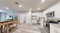 Located at 124 Church Center Rd in Sanford, NC, this single-floor, 2-bedroom, 2-bathroom residence offers a thoughtfully designed layout that maximizes comfort and functionality. The open-concept living, dining, and kitchen area serves as the heart of the home, featuring light wood-look flooring, recessed lighting, and a ceiling fan. The kitchen is well-equipped with crisp white shaker cabinetry, granite countertops, subway tile backsplash, and a full suite of stainless steel appliances, including a refrigerator, range, microwave, and dishwasher. A pantry provides additional storage convenience. The living area is bright and welcoming, with a large window that draws in natural light. Both bedrooms are carpeted and include ceiling fans and generous windows; the primary bedroom offers a comfortable, private retreat. The two bathrooms are finished with granite-topped vanities, white cabinetry, and wood-look tile flooring. A dedicated laundry room with an in-unit washer is tucked conveniently off the main living space. Additional highlights include two closets, a hallway, a utility room, and an entrance. The overall aesthetic is clean and modern, with a neutral palette that creates a bright, cohesive atmosphere throughout.