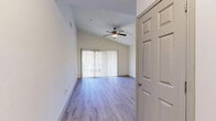 Located at 1970 Peachford Rd in Dunwoody, GA, this well-appointed 2-bedroom, 2-bathroom residence offers a thoughtfully designed single-floor layout. Light wood-style flooring runs throughout, creating a cohesive and contemporary feel across the space.

The open-concept living, dining, and kitchen area serves as the heart of the home. The living room features soaring vaulted ceilings with a ceiling fan, and large sliding glass doors dressed in vertical blinds open to an outdoor balcony, filling the room with natural light and providing pleasant exterior views.

The kitchen is well-equipped with stainless steel appliances — including a refrigerator, range, microwave, and dishwasher — complemented by granite countertops, a subway tile backsplash, and sage-toned cabinetry. A window above the sink brings in additional natural light.

Both bedrooms are bright and well-sized, with the generously proportioned primary bedroom offering ample space. The second bedroom features a ceiling fan and closet access. Five closets throughout the unit provide exceptional storage. Both bathrooms are finished with granite vanity countertops and full tub/shower combos accented by clean white subway tile surrounds. A dedicated entrance and hallway complete this functional and inviting layout.