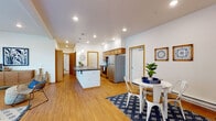 Located at 4185 East Poleline Avenue in Post Falls, Idaho, this single-floor unit offers a thoughtfully designed layout with a clean, contemporary aesthetic. Warm wood-tone trim and doors complement crisp white walls throughout, creating a cohesive and inviting atmosphere.

The open-concept kitchen is a functional centerpiece, featuring stainless steel appliances including a full-size refrigerator and range, warm wood cabinetry, dark countertops, and a peninsula with pendant lighting overhead. The kitchen flows naturally into a dedicated dining area and connects to the rest of the living space, making it ideal for everyday living and entertaining.

The living room is bright and welcoming, with multiple large windows that invite generous natural light and provide views of the surrounding exterior. A private door leads directly outside, adding convenience and accessibility.

The bedrooms offer comfortable retreats, each with plush carpeting and ample natural light from well-positioned windows. One bedroom features a sliding wood-door closet with built-in rod storage, while the other benefits from a cozy, softly lit ambiance.

Two full bathrooms serve the unit, each finished with wood-tone vanity cabinetry, light countertops, and durable flooring. One bathroom includes a full tub-shower combination, while the other provides a standalone vanity and toilet. Wood-look flooring runs throughout the main living areas, tying the entire space together with warmth and consistency.